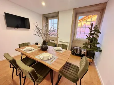 a dining room with a wooden table and chairs at Downtown Premiu in center of Porto 3BR with AC in Porto