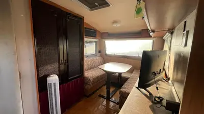 a small room with a table and a window at Caravan Experience in Santa Justa