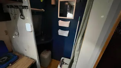 a small bathroom with a toilet and a sink at Caravan Experience in Santa Justa