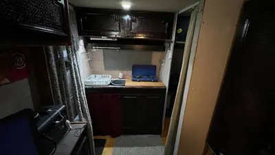 an rv kitchen with a laptop computer on a counter at Caravan Experience in Santa Justa