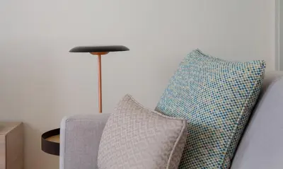 two pillows sitting on a couch next to a lamp at GuestReady - Catorze de Outubro Houses 417 in Vila Nova de Gaia