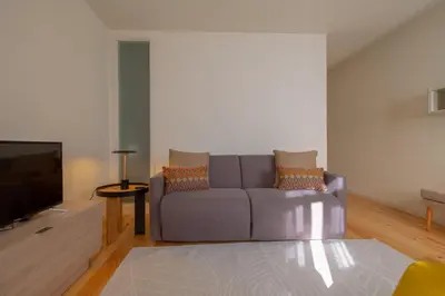 a living room with a couch and a tv at GuestReady - Catorze de Outubro Houses 417 in Vila Nova de Gaia