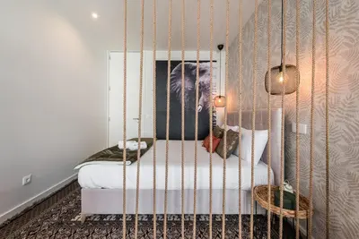 a bedroom with a bed in a swing at GuestReady - Industrial stay in downtown Porto in Porto