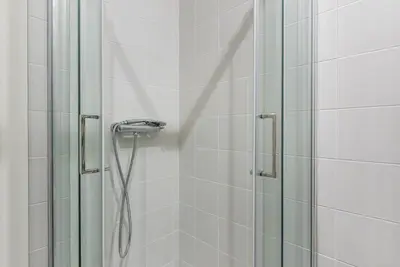 a shower with a shower head in a bathroom at GuestReady - Industrial stay in downtown Porto in Porto