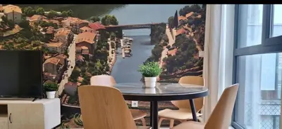 a room with a table and a view of a bridge at Fontainhas Douro Flats in Porto