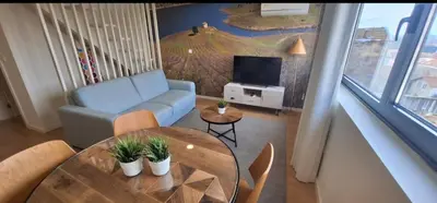 a living room with a blue couch and a table at Fontainhas Douro Flats in Porto