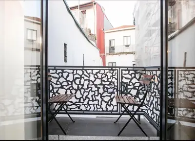 two chairs on the balcony of a building at Vila Terra Studio III in Vila Nova de Gaia
