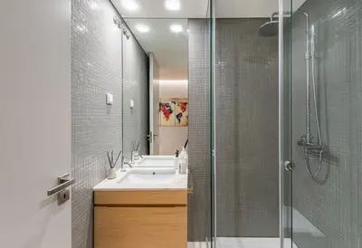 a bathroom with a sink and a glass shower at NEW LUX 2BR Flat Free Parking Cedofeita Porto in Porto
