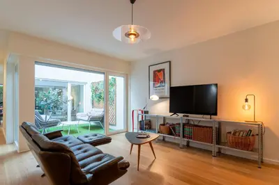 a living room with a couch and a flat screen tv at Campanhã Duplex by Porto Stories in Porto