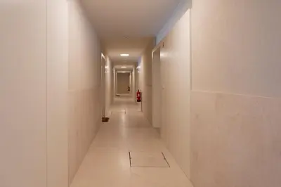 a long hallway with white walls and a long corridor at Campanhã Duplex by Porto Stories in Porto
