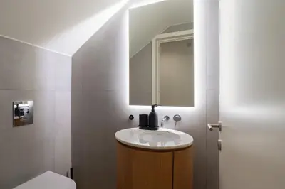a bathroom with a sink and a mirror at Campanhã Duplex by Porto Stories in Porto