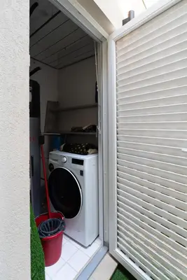a washer and dryer in a room with a window at Campanhã Duplex by Porto Stories in Porto