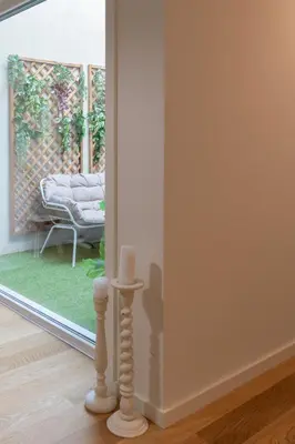 a room with a window with a couch in a yard at Campanhã Duplex by Porto Stories in Porto