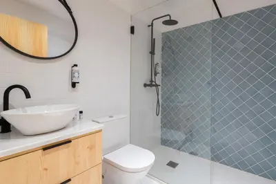 a bathroom with a toilet and a sink and a mirror at Prime Clerigos by Hosty in Porto