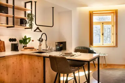 a kitchen with a table and chairs and a window at Prime Clerigos by Hosty in Porto