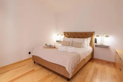 a bedroom with a large bed with two lamps at Prime Clerigos by Hosty in Porto
