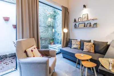 a living room with a couch and a table at Vila Terra Studio Studio I in Vila Nova de Gaia