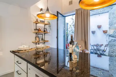 a kitchen with a counter with a bottle of wine at Vila Terra Studio Studio I in Vila Nova de Gaia