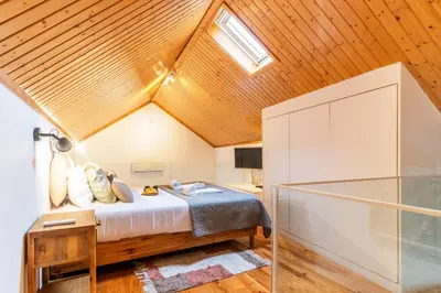 a bedroom with a bed and a skylight at Vila Terra Studio Studio I in Vila Nova de Gaia