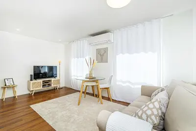 a living room with a couch and a table at Bombarda 250 by LovelyStay in Porto