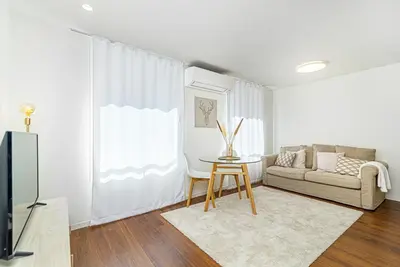 a living room with a couch and a table at Bombarda 250 by LovelyStay in Porto