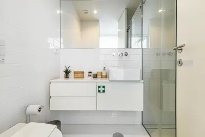 a white bathroom with a shower and a toilet at Bombarda 250 by LovelyStay in Porto