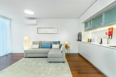 a living room with a couch and a kitchen at Bombarda 250 by LovelyStay in Porto