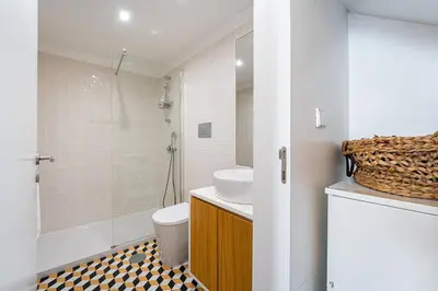 a bathroom with a sink and a toilet and a shower at GuestReady - Mezzanine comfort in Porto in Porto