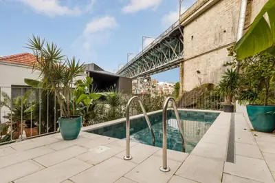 an apartment with a swimming pool and a bridge at Douro's Bridge View - Swimming pool in Vila Nova de Gaia