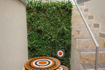 a staircase with a green wall with a target on it at Chillout Trindade Home by Vacationy in Porto