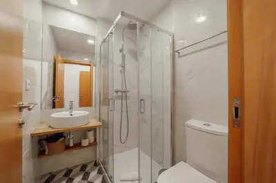 a bathroom with a sink and a mirror at Chillout Trindade Home by Vacationy in Porto
