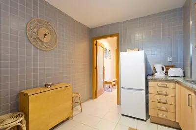 a kitchen with a white refrigerator and a counter at Aposentus - Contemporary Comfort in Porto