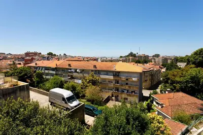 a truck parked in a parking lot in front of a building at Aposentus - Contemporary Comfort in Porto