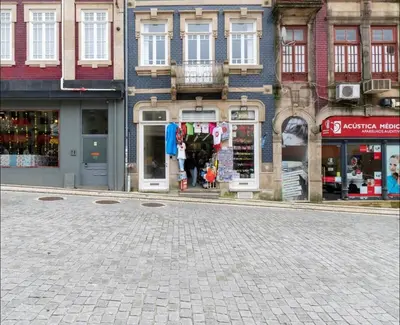 a bedroom with a bed and a large window at Bolhão Market Apartment in Porto