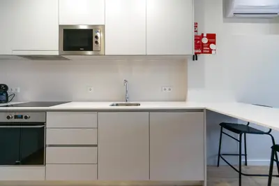 a bathroom with a sink and a glass shower at Bolhão Market Apartment in Porto