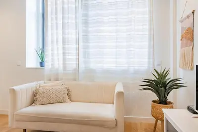 a bedroom with a bed and a desk and a table at Paraíso City Stay I in Porto