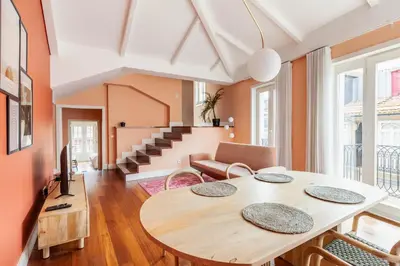 a living room with a table and a couch at Superb Apartment in the HEART of Historical Center in Porto