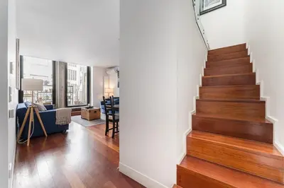 a staircase in a living room with wood floors at City-Center Apartments with Mezzanine and Terrace in Porto
