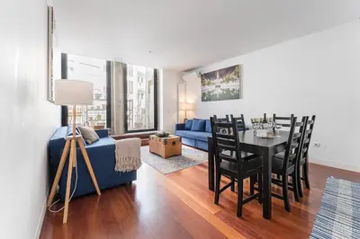 a living room with a blue couch and a table at City-Center Apartments with Mezzanine and Terrace in Porto