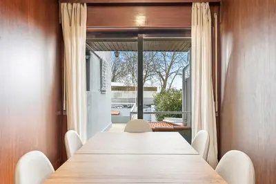 a white bedroom with a bed and a mirror at A unique experience in Porto in Porto