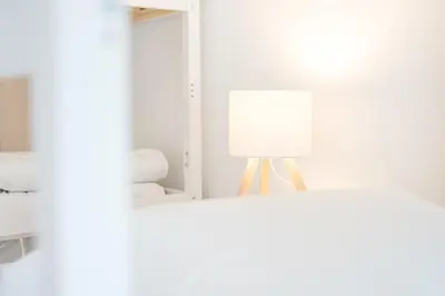 a bunch of pillows sitting on a bed at A unique experience in Porto in Porto