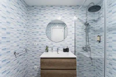a shower head in a bathroom with blue and white tiles at A unique experience in Porto in Porto