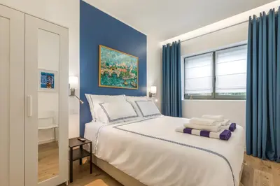 a bedroom with a large bed with blue walls at Douro's Balcony View - Swimming pool in Vila Nova de Gaia