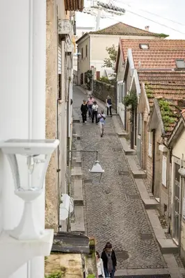 a group of people walking down a narrow street at Douro's Balcony View - Swimming pool in Vila Nova de Gaia