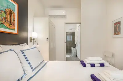 a white bed with two towels on top of it at Douro's Balcony View - Swimming pool in Vila Nova de Gaia