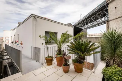 a white house with plants on a balcony at Douro's Balcony View - Swimming pool in Vila Nova de Gaia