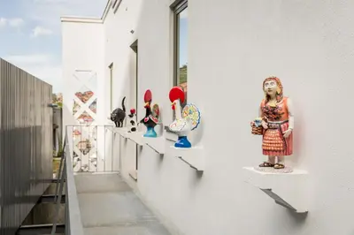 a group of figurines on shelves on a wall at Douro's Balcony View - Swimming pool in Vila Nova de Gaia