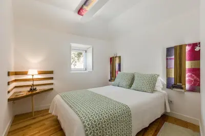 a white bedroom with a bed and a desk at By the River 2 by Porto Dream Stays in Porto