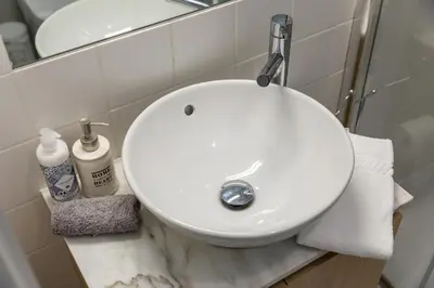 a white sink in a bathroom with a mirror at By the River 2 by Porto Dream Stays in Porto