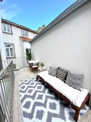 a couch sitting on the side of a building at VIVA - Rooftop Terrace View Flat in Porto